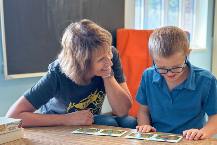 A teacher working with a student utilizing picture cards.