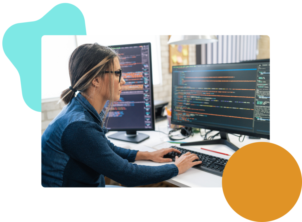 Woman at a computer with code on the screen